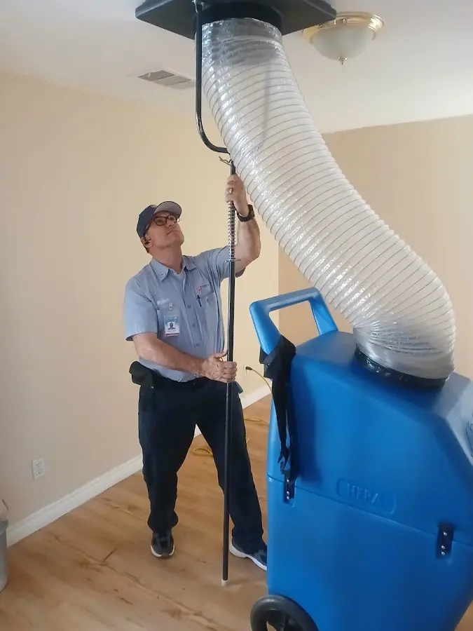 Furnace Tune-Up technician using HEPA equipment in Harvey